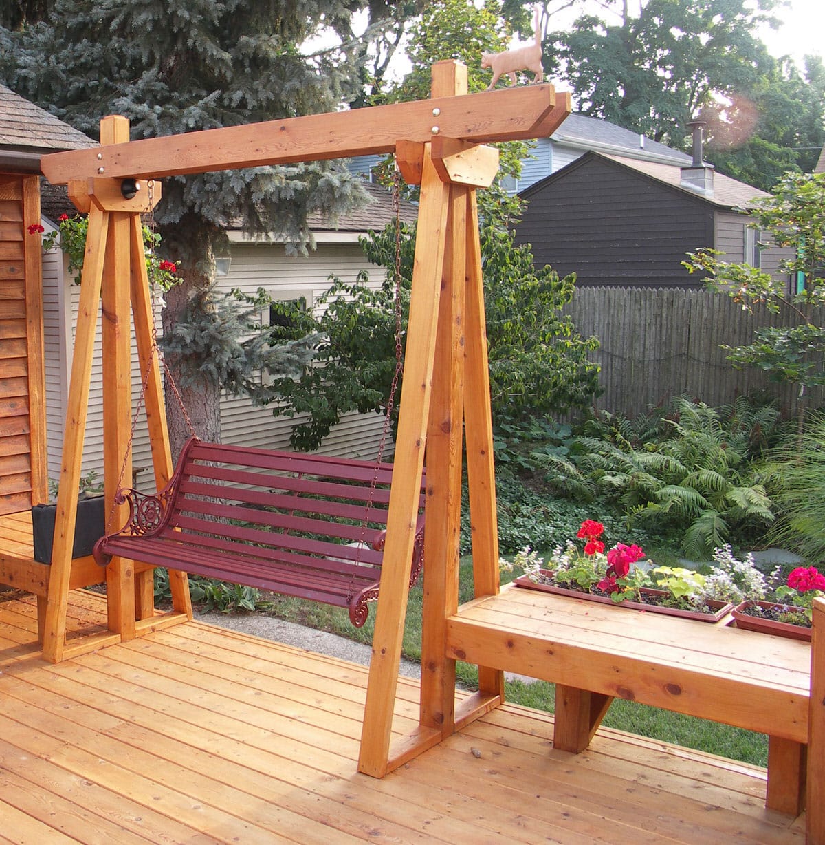 Custom deck contractor project from Precision Decks & Sunrooms. A deck featuring a wooden swing love seat.