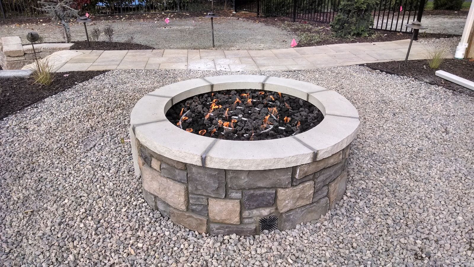 A backyard fire pit. Design and build services by Precision Decks & Sunrooms