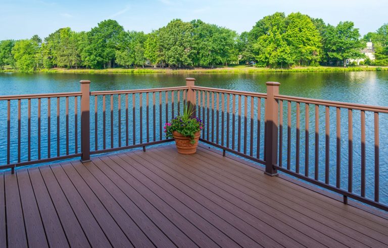 Low maintenance backyard designs, similar to this design of a deck overlooking a small lake, is why Precision Decks & Sunrooms is a preferred choice in West Michigan.