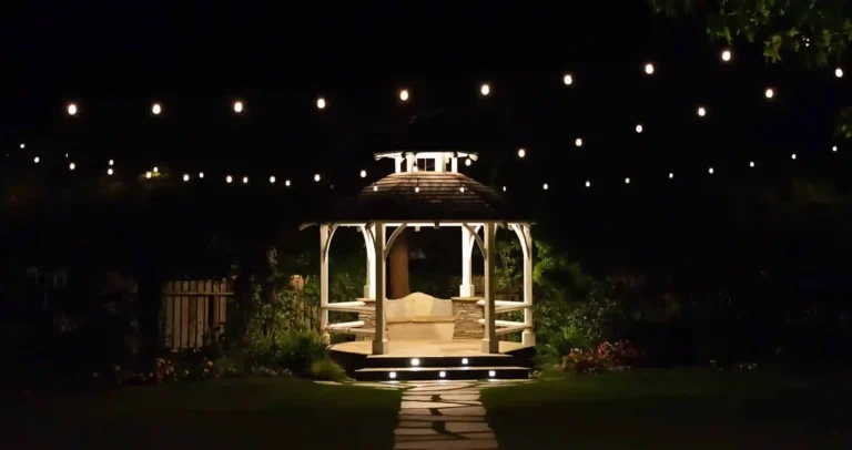 Patio lighting ideas take many forms, including (as shown) string lights around a Gazebo at night, or lights within the steps of a walkway.