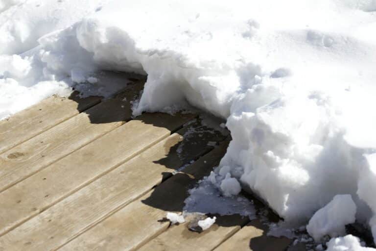 Winter deck protection can help your deck when the weather beats it up. A deck covered in 4 inches of snow.