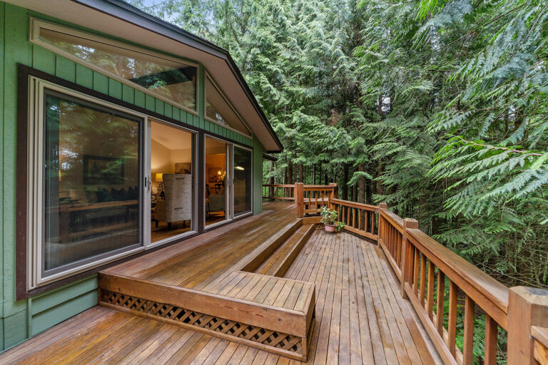 beautiful home with an elevated high end deck with bench seating and a custom design