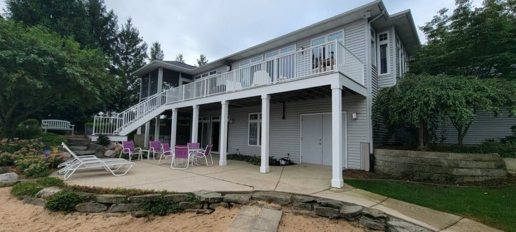 white railing raised porch by pool