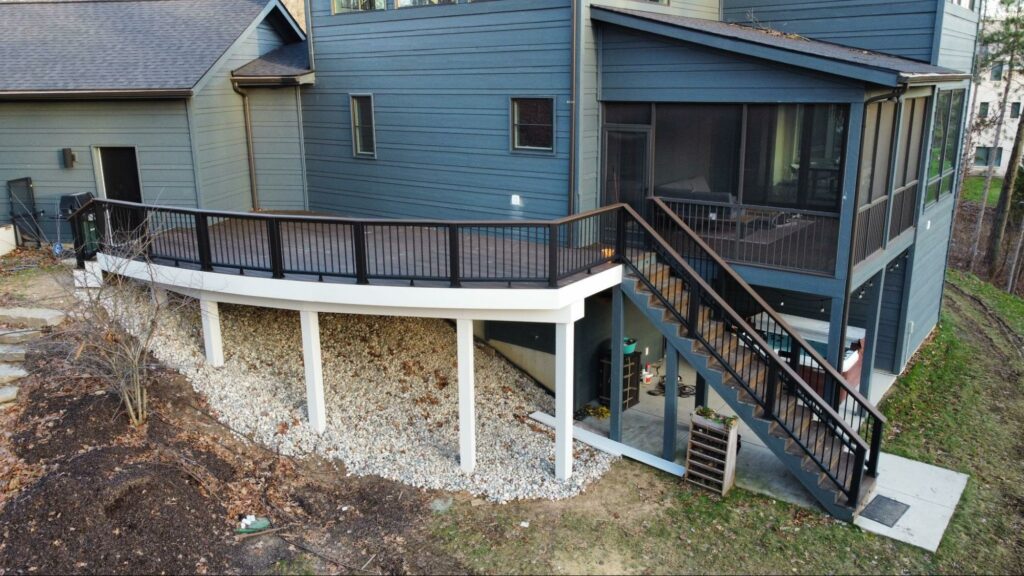 Photo of an elevated deck with a covered deck that incorporates privacy screens