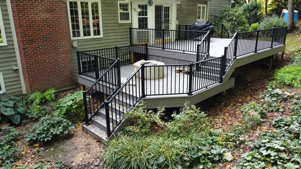 multi-level decks attached to the back of a home featuring deck steps and deck railings.