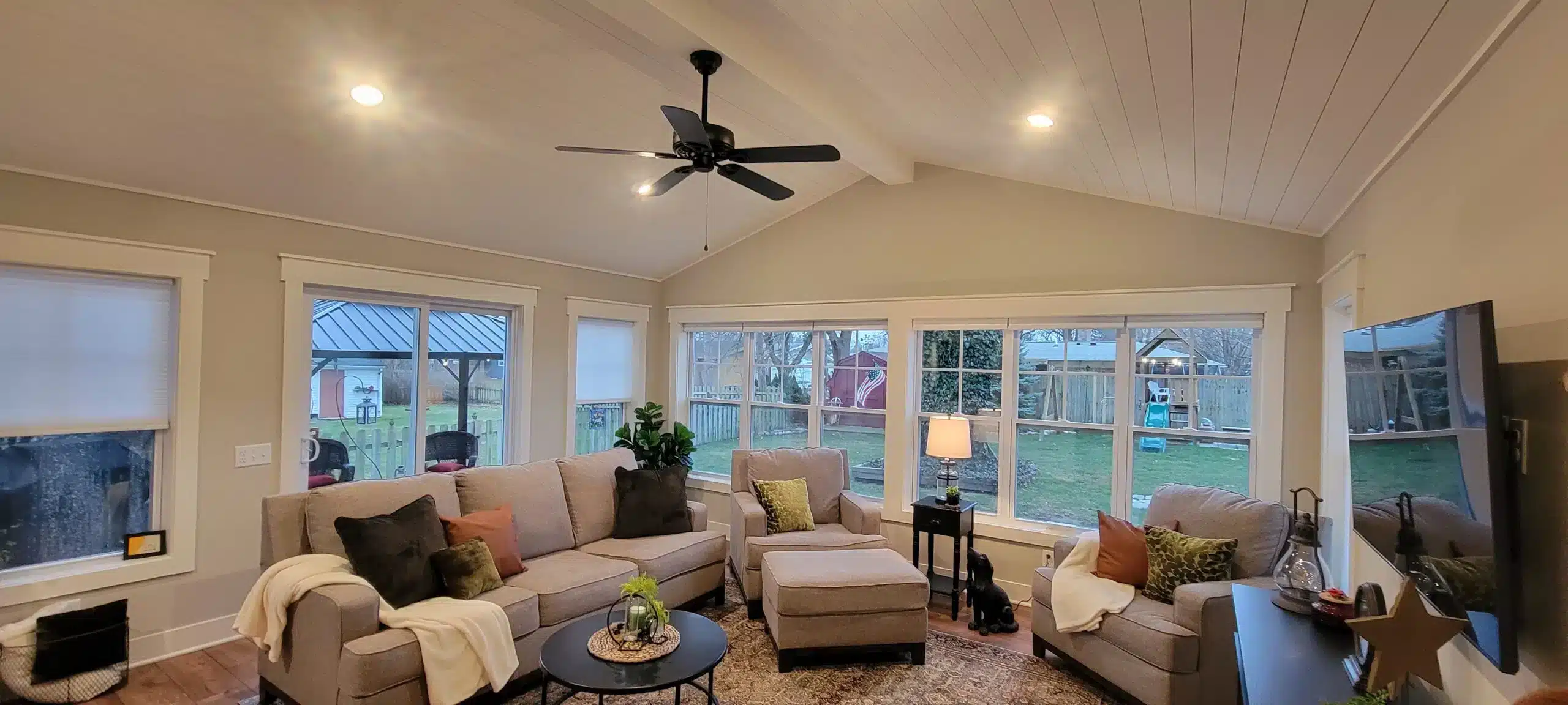 custom sunroom with ceiling fan and furniture