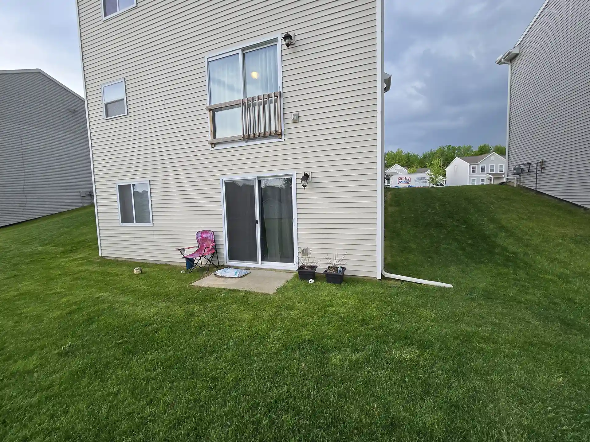 photo of the back of a house before a deck project . How to Prepare for Spring Outdoor Living Projects