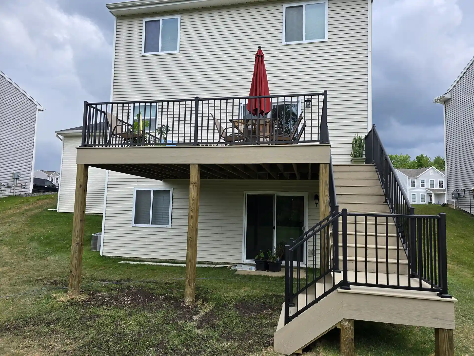 photo of completed deck project with elevate deck, deck steps with a landing platform, and deck railing - How to Prepare for Spring Outdoor Living Projects