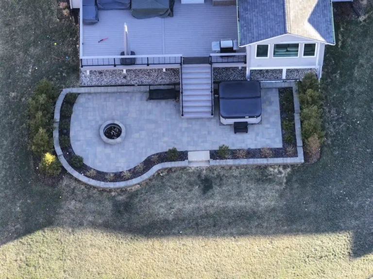 aerial view of custom deck with a patio that has a fire pit and hot tub