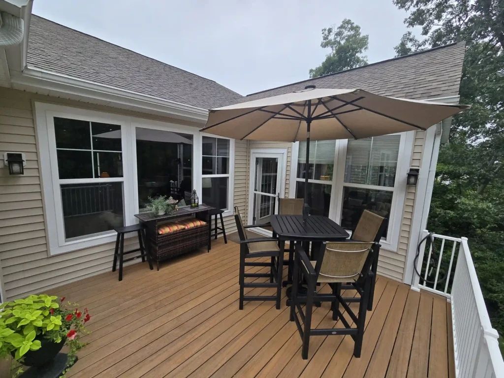 Cozy AZEK deck with dining set and Westbury railings overlooking greenery