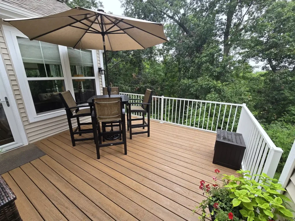 Cozy AZEK deck with dining set and Westbury railings overlooking greenery