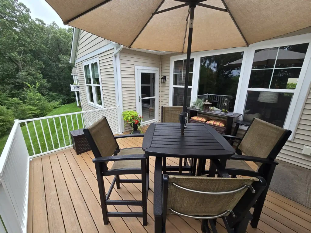 Spacious condo deck with AZEK decking, umbrella, and seating area