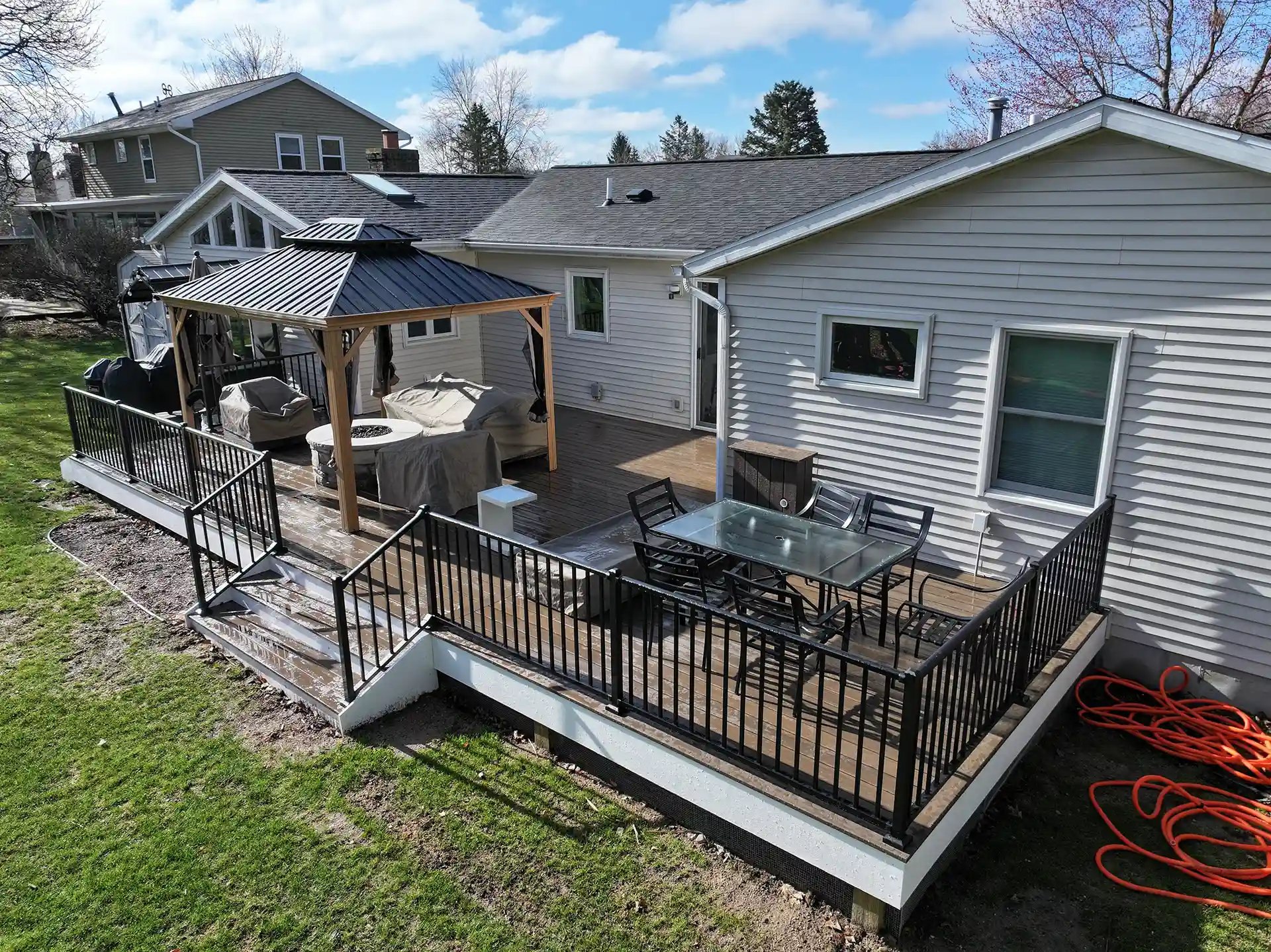 photo of a shade structure on a custom deck with a fire pit
