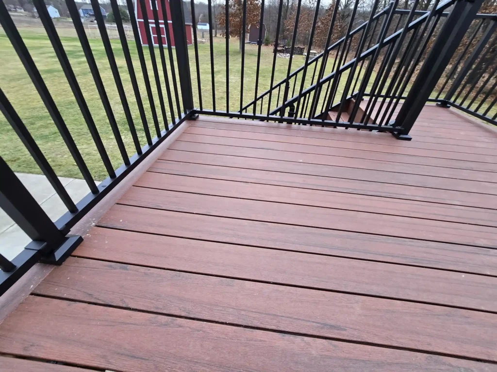 photo of new deck surface with composite decking and modern railings