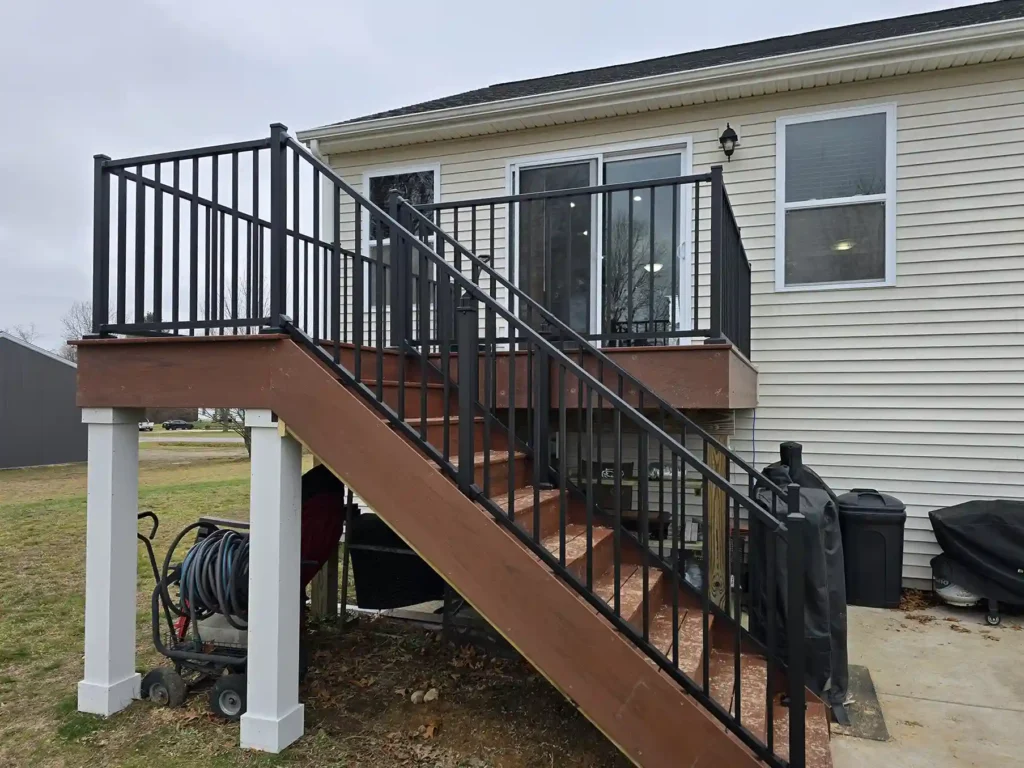 Photo of an outdated to outstanding deck in Rockford, MI, with Armadillo decking and black aluminum railings