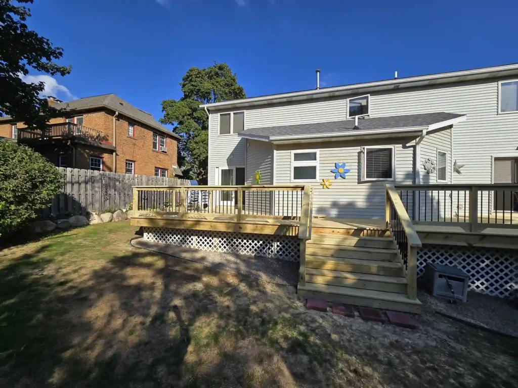 Backyard view showcasing the new spacious deck in East Grand Rapids, it is a one-level deck and improved layout