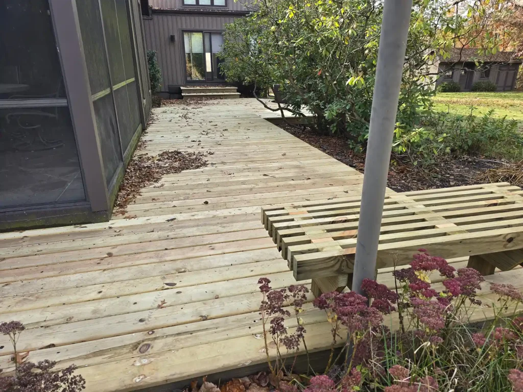 photo of Rebuilt walkway with new decking and a custom wooden bench.