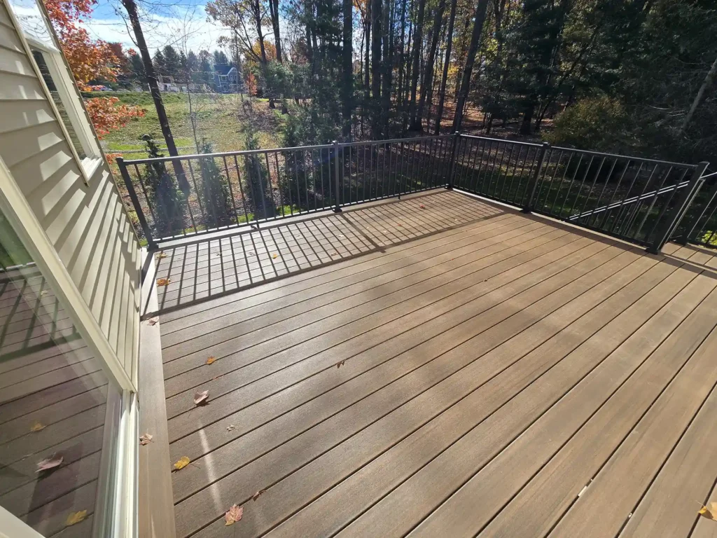 Updated deck with new flooring and black metal railings.