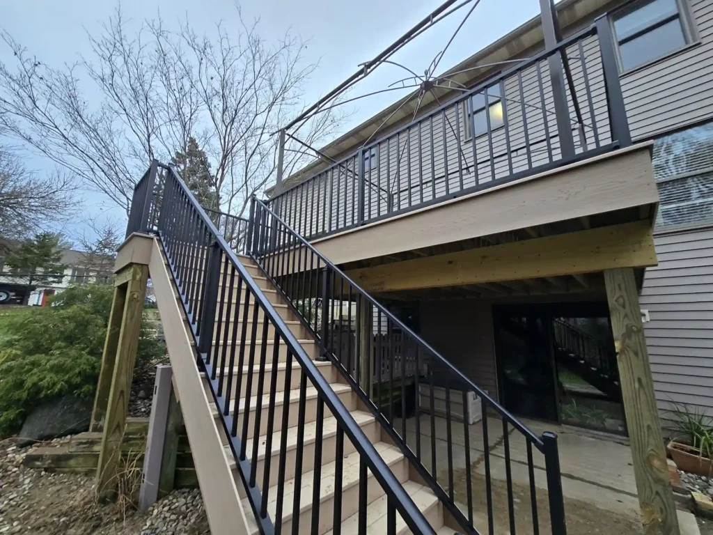 Side view of the renovated deck and staircase with a securely anchored pergola