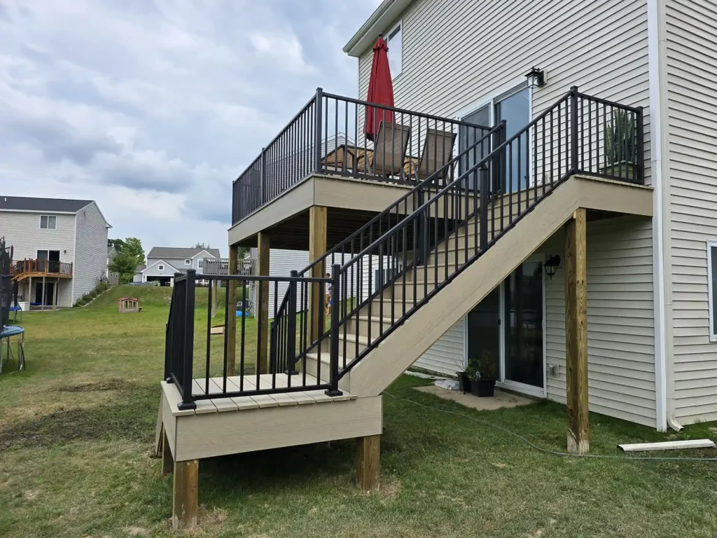 Side view of an elevated deck with stairs leading to the backyard.