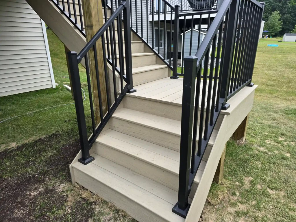 An elevated deck with a staircase with landing