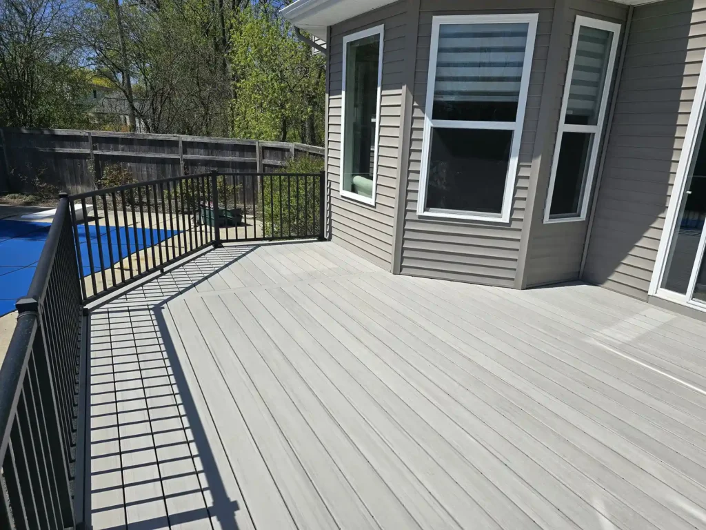 Rear view of the home showcasing the extended poolside deck.