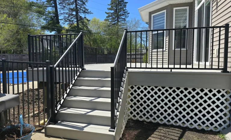 photo of a composite deck with black metal railing to support a blog post about the best time to build a deck