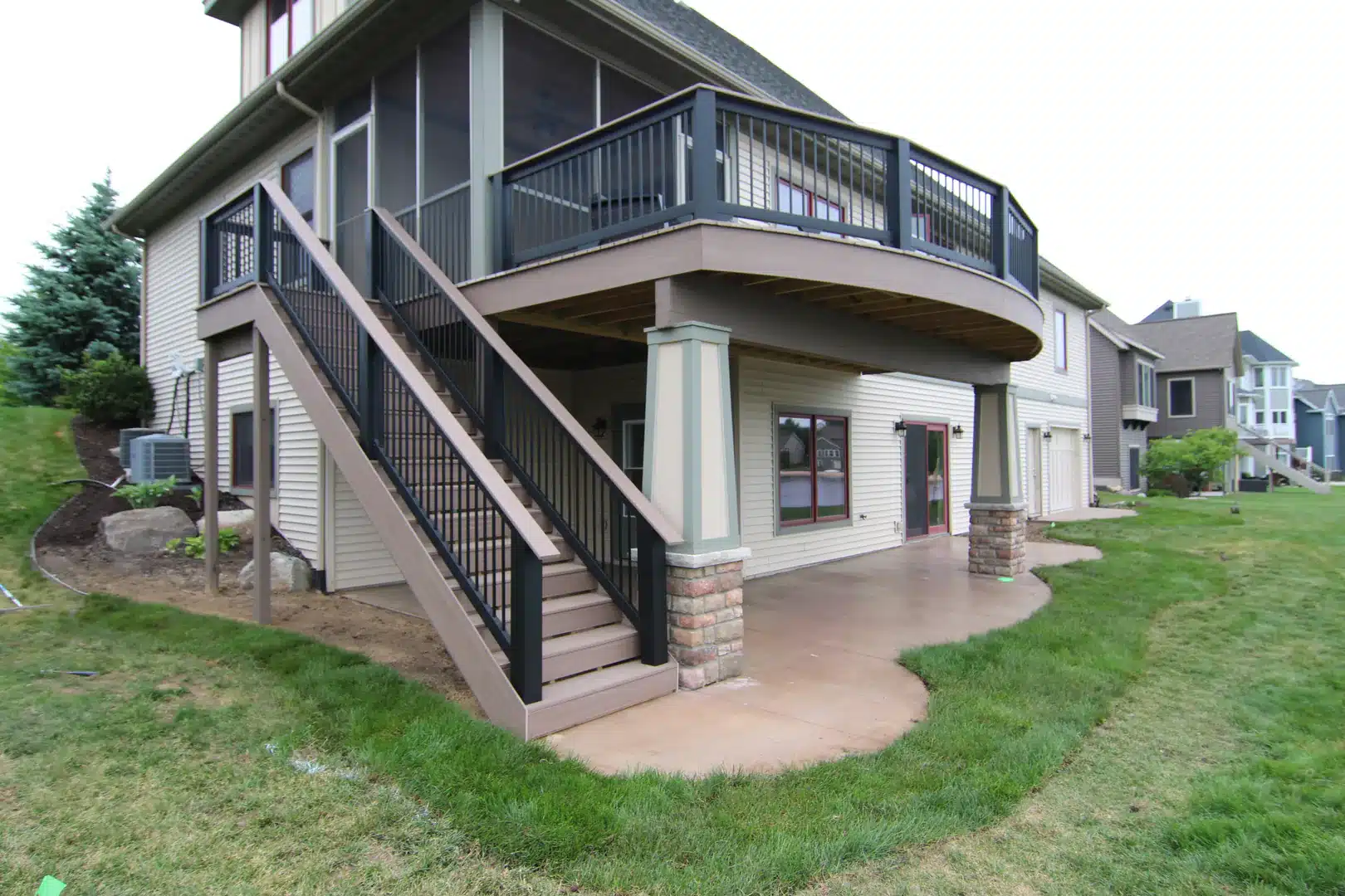 Composite deck connected to a screened outdoor room