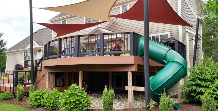 Deck safety rails are vital when the intent is for chirldren to use it. A deck with a tunnel slide going from upper deck to lower area.