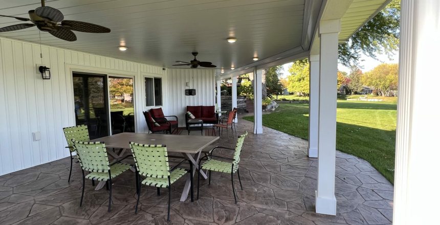 Is a deck better than a patio? A stamped concrete patio undeneath a new deck built by Precision Decks & Patios.