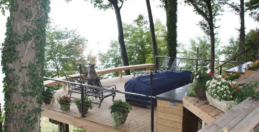 A custom deck design in Fennville, Michigan. The deck offers a treehouse vibe as its elevated among natural cedar.